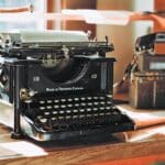 classic black typewriter on brown wooden desk